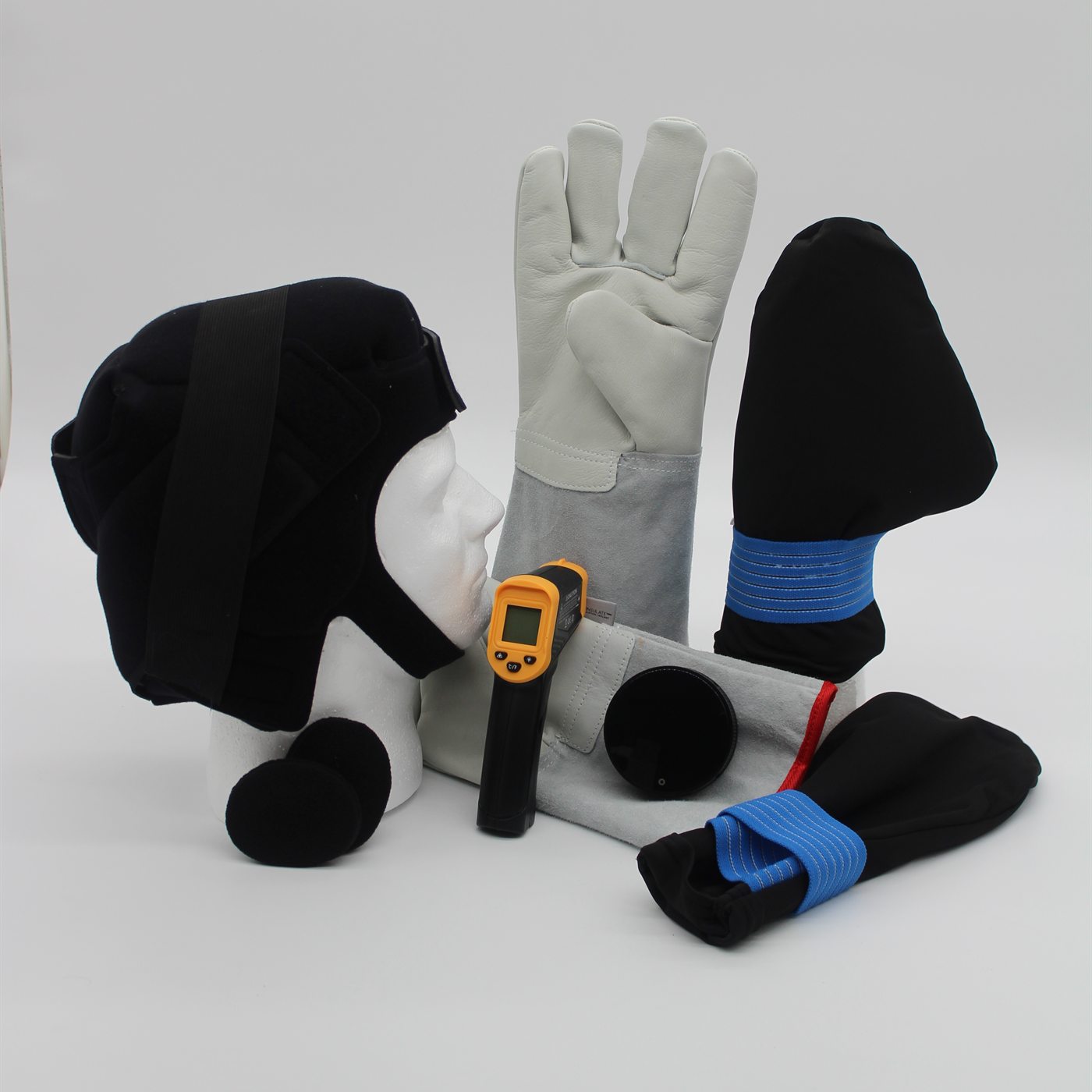 The Dalthera kit laid out: cold cap, dry ice glove, infrared thermometer, and cold gloves and socks